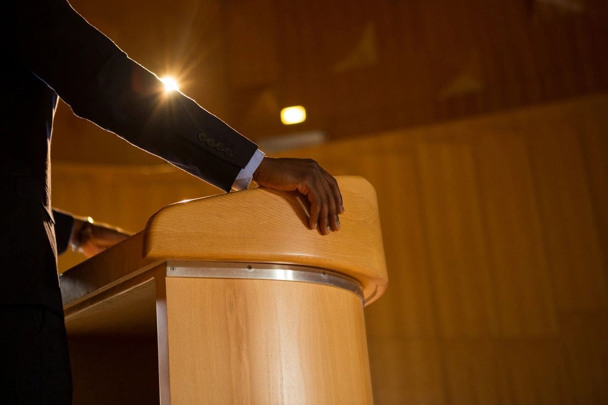 A person is standing at the top of a podium